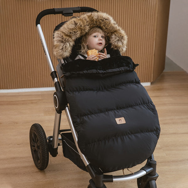 Stay warm and dry with the Winter Windproof and Waterproof Stroller Footmuff for babies 0-3 years old. Cozy padding, adjustable hood, and waterproof material keep your baby comfortable during outdoor walks black color  