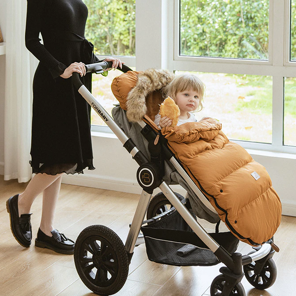 Stay warm and dry with the Winter Windproof and Waterproof Stroller Footmuff for babies 0-3 years old. Cozy padding, adjustable hood, and waterproof material keep your baby comfortable during outdoor walks brown color 